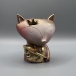 Meet "The Royal Vulpine" at Boba's Plant. This charming fox planter features a golden crown and leaf detail with a warm sunset texture. Perfect for small succulents and nursery decor!